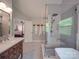 Bright bathroom featuring a soaking tub, glass shower, and vanity with double sinks at 5900 Colwick Nw Ct, Concord, NC 28027