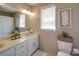 Bright bathroom with a decorative mirror, a toilet, and storage at 5900 Colwick Nw Ct, Concord, NC 28027
