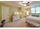 Bright bedroom with a ceiling fan, a window, a bed, and a dresser at 5900 Colwick Nw Ct, Concord, NC 28027