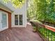 View of the home's wooden deck, featuring a wooden and iron railing and flower pot at 5900 Colwick Nw Ct, Concord, NC 28027