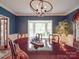 Charming dining room featuring wainscoting, bay window, and a stylish chandelier over the dining table at 5900 Colwick Nw Ct, Concord, NC 28027