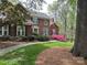 Charming brick home featuring lush landscaping and a welcoming entrance at 5900 Colwick Nw Ct, Concord, NC 28027