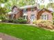 Charming two-story brick home with a well-manicured lawn and a welcoming blue front door at 5900 Colwick Nw Ct, Concord, NC 28027