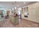 Open kitchen featuring white cabinets, stainless steel appliances, a butcher block island, and wood floors at 5900 Colwick Nw Ct, Concord, NC 28027