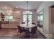 Bright eat-in kitchen with stainless steel appliances, butcher block island, white cabinets and wood floors at 5900 Colwick Nw Ct, Concord, NC 28027