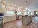 Updated kitchen featuring white cabinets, stainless steel appliances, granite countertops, and wood flooring at 5900 Colwick Nw Ct, Concord, NC 28027