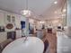 Bright, spacious kitchen featuring white cabinetry, stainless steel appliances, and a large center island at 5900 Colwick Nw Ct, Concord, NC 28027
