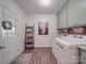 Bright laundry room with a side-by-side washer and dryer, storage, and shelving at 5900 Colwick Nw Ct, Concord, NC 28027