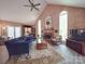 Spacious living room with a vaulted ceiling, brick fireplace, and large windows filling the room with light at 5900 Colwick Nw Ct, Concord, NC 28027