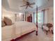 Bedroom features a four-poster bed, neutral decor, and soft natural light streaming through the window at 5900 Colwick Nw Ct, Concord, NC 28027