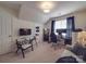A well lit room featuring an organized office with a desk, chair, and couch at 5900 Colwick Nw Ct, Concord, NC 28027
