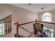 Upper landing featuring elegant chair, staircase and natural light at 5900 Colwick Nw Ct, Concord, NC 28027