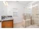 Updated bathroom featuring granite counters, ceramic tile flooring, and a glass-enclosed tile shower at 6033 Bountiful St # 201, Belmont, NC 28012