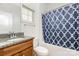 Bright bathroom features a granite countertop, wood vanity and a shower with a blue patterned curtain at 6033 Bountiful St # 201, Belmont, NC 28012