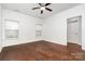 This bedroom features hardwood floors, two windows for ample natural light, and a classic ceiling fan at 6033 Bountiful St # 201, Belmont, NC 28012