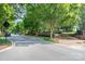 Inviting community entrance featuring lush trees, brick accents, and a decorative fountain, creating an elegant welcome at 6033 Bountiful St # 201, Belmont, NC 28012