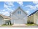 Attached two-car garage featuring gray siding and a white garage door, providing convenient parking and storage at 6033 Bountiful St # 201, Belmont, NC 28012