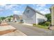 Street view showcasing multiple attached two-car garages with gray and green siding, offering ample parking at 6033 Bountiful St # 201, Belmont, NC 28012