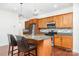 Charming kitchen with granite counters, stainless appliances, and wood cabinets at 6033 Bountiful St # 201, Belmont, NC 28012