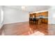Spacious living room with hardwood floors adjacent to an eat-in kitchen and island seating at 6033 Bountiful St # 201, Belmont, NC 28012