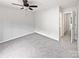 Bright bedroom featuring soft carpeting, ceiling fan, and neutral tones for a serene atmosphere at 6121 Dane Dr, Dallas, NC 28034
