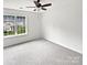 Bedroom featuring neutral walls, ceiling fan, carpet, and bright window view at 6121 Dane Dr, Dallas, NC 28034