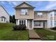 Charming two-story townhome featuring beige siding, a well-maintained lawn, and a welcoming front entrance at 6121 Dane Dr, Dallas, NC 28034