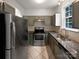 Functional kitchen featuring stainless steel appliances, granite countertops, and ample cabinet space at 6121 Dane Dr, Dallas, NC 28034