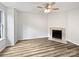Bright living room featuring neutral paint and floors with a fireplace and ceiling fan, offering a calm and inviting atmosphere at 6121 Dane Dr, Dallas, NC 28034