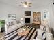 Bright living room with modern furnishings, fireplace, and wood floors, creating a cozy and inviting atmosphere at 6121 Dane Dr, Dallas, NC 28034