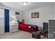 Bedroom featuring a comfortable bed, wall decor, and window for natural light at 7604 Tanglewood Way, Denver, NC 28037
