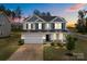 Charming two-story home with a two-car garage, manicured lawn, and beautiful landscaping at 7604 Tanglewood Way, Denver, NC 28037