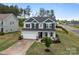 Well-maintained two-story home with a two-car garage and a neatly landscaped front yard at 7604 Tanglewood Way, Denver, NC 28037