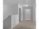 A well-lit hallway that provides access to multiple rooms in the home at 7604 Tanglewood Way, Denver, NC 28037