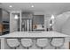 Spacious kitchen island with bar stool seating and a double sink, perfect for entertaining and meal preparation at 7604 Tanglewood Way, Denver, NC 28037