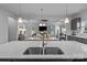 Open concept kitchen featuring a large island with sink and views into dining and living areas, great for gatherings at 7604 Tanglewood Way, Denver, NC 28037