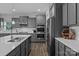 Modern gray kitchen with stainless steel appliances, quartz countertops, and ample cabinet space at 7604 Tanglewood Way, Denver, NC 28037