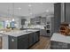 Well-equipped kitchen with gray cabinets, stainless appliances, a large island, and open sightlines to dining area at 7604 Tanglewood Way, Denver, NC 28037