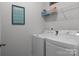 Bright laundry room with washer, dryer and shelving at 7604 Tanglewood Way, Denver, NC 28037