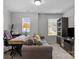 Living room featuring a sofa, desk, and a large window at 7604 Tanglewood Way, Denver, NC 28037