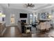 Cozy living room with a fireplace, large windows, comfortable seating, and hardwood flooring at 7604 Tanglewood Way, Denver, NC 28037