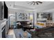 Open-concept living room with a fireplace, ceiling fan, and direct view of kitchen at 7604 Tanglewood Way, Denver, NC 28037