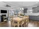 Open-concept dining and living area with plenty of seating, modern furnishings, and hardwood flooring at 7604 Tanglewood Way, Denver, NC 28037