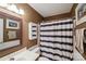 Bathroom featuring vanity, toilet, shower with a striped curtain and wall art at 8105 Castlemaine Dr, Matthews, NC 28104
