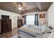 Bright bedroom featuring a tray ceiling, wood floor, and natural light from a large window at 8105 Castlemaine Dr, Matthews, NC 28104