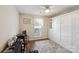 Cozy bedroom showcasing a built in wardrobe, rug, ceiling fan, and a desk at 8105 Castlemaine Dr, Matthews, NC 28104