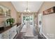 Formal dining room featuring large windows, decorative lighting, and hardwood flooring at 8105 Castlemaine Dr, Matthews, NC 28104