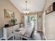 Spacious dining room featuring large windows, decorative lighting, and hardwood flooring at 8105 Castlemaine Dr, Matthews, NC 28104