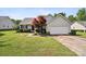 Charming single-story home with well-manicured lawn, lovely landscaping and an attached two-car garage at 8105 Castlemaine Dr, Matthews, NC 28104