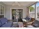 Inviting screened-in patio with comfortable seating, ceiling fan and sliding glass doors at 8105 Castlemaine Dr, Matthews, NC 28104